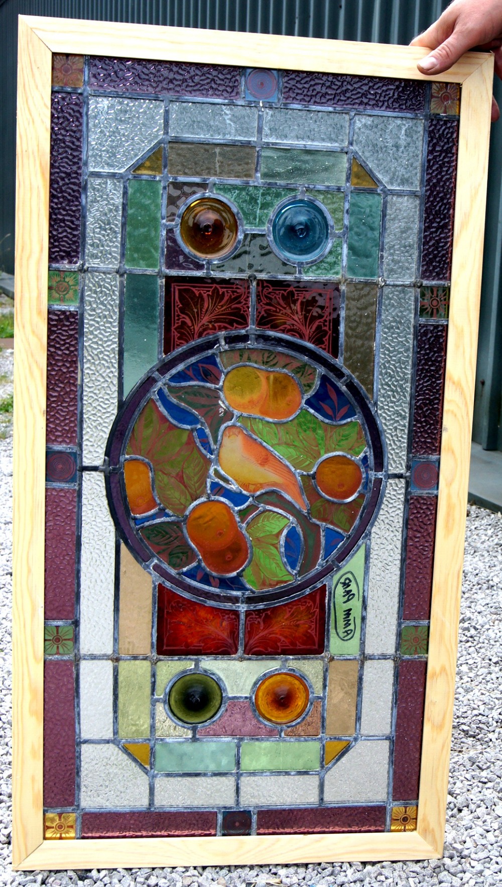 a vibrant painted and leaded glass bird window
