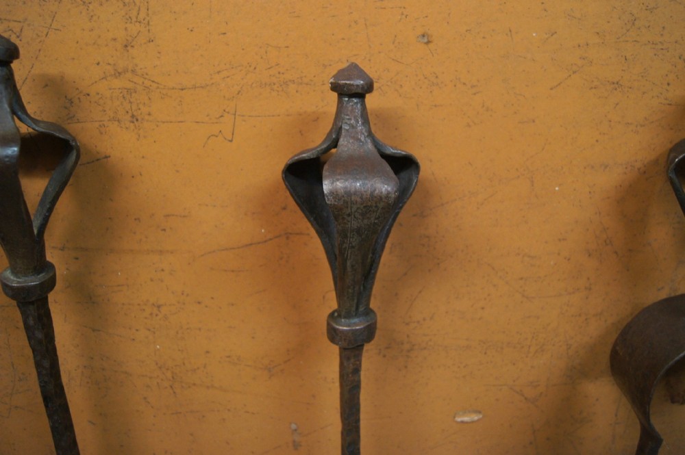 a superb arts and crafts hammered steel andirons and fire tools set