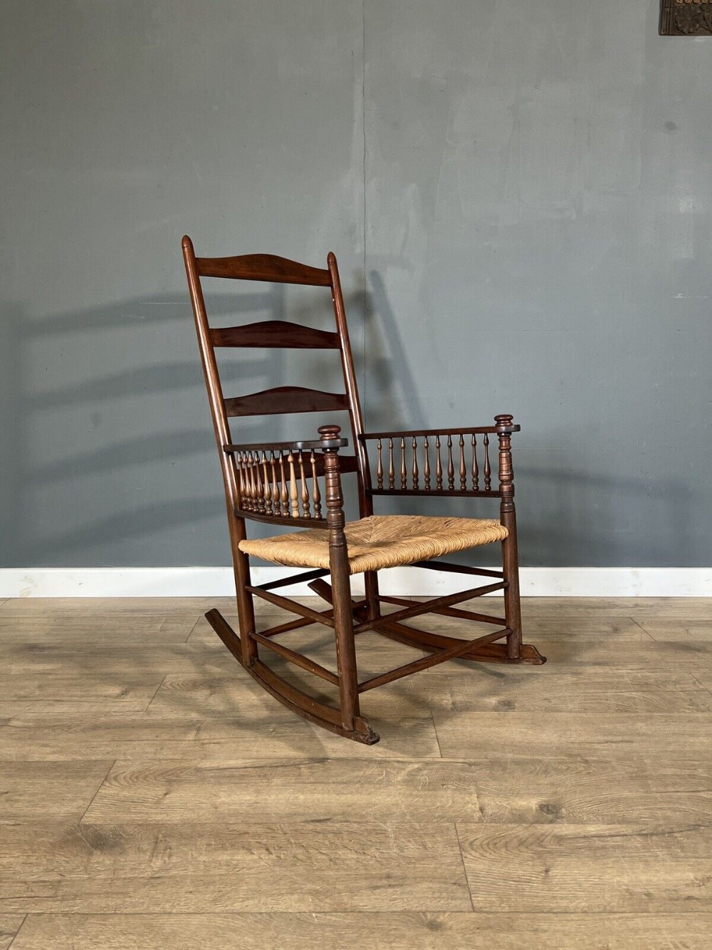 a very stylish mahogany rocking chair in the shaker style