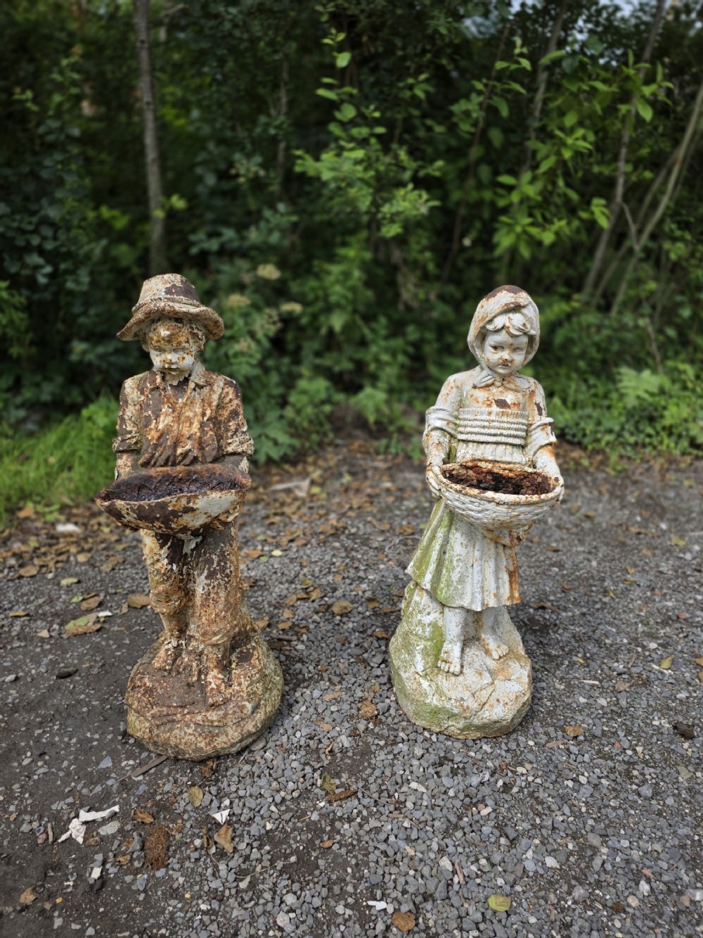 pair of early 20th century cast iron boy and girl statues
