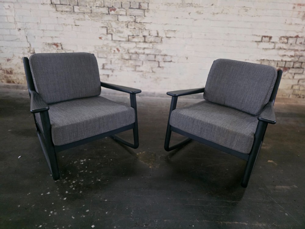 pair of midcentury style rocking chairs with arms